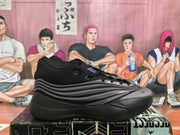 Side profile of one black and gray Adidas sneaker showing the layered side detailing and thick outsole.