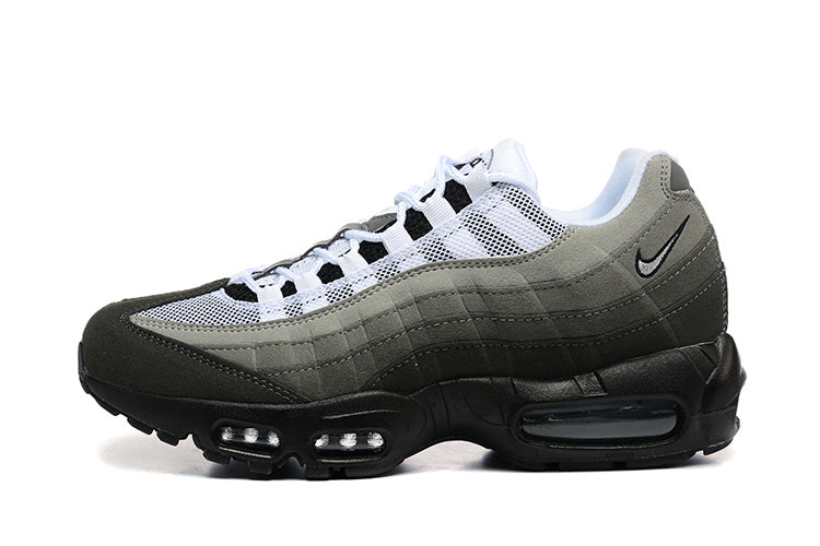 Side view of grey, black, and white Nike Air Max 95-style sneakers with mesh panels and visible sole cushioning.