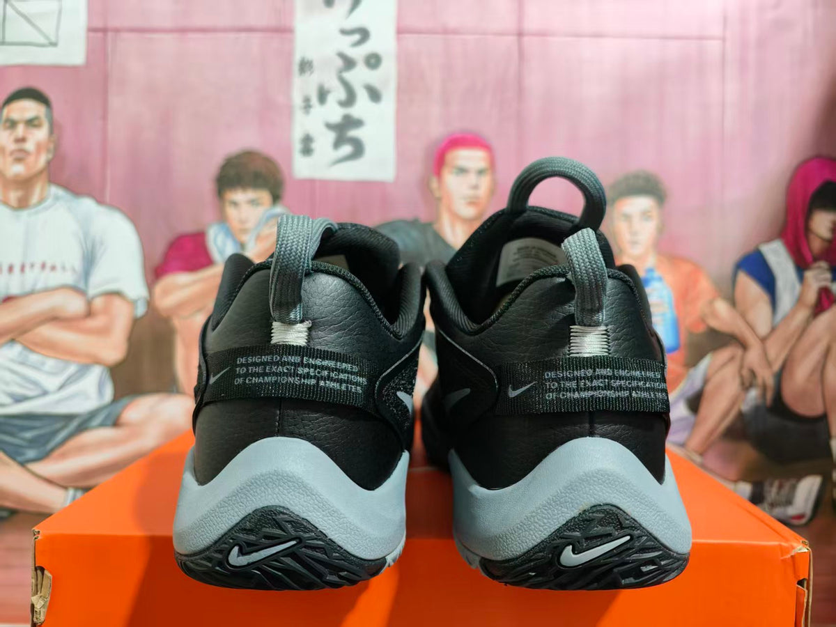 Rear view of black Nike basketball shoes with grey midsoles and heel details