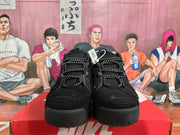 Front view of black Nike sneakers with rope-style laces, rounded lace hardware, and padded high-top construction.