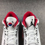 Close top view showing white laces, perforated panels and contrasting tongue graphics.