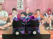 Rear view of the purple Nike sneakers showing black heel panels, purple collars, side graphics, and black outsoles.