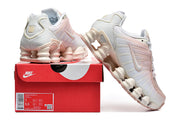 White and pale pink Nike Shox TL sneakers displayed with a Nike shoebox; the box label shows a sample size.