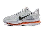 Side view of a grey Nike Pegasus Premium shoe with black Swoosh and orange-colored midsole section.
