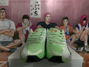Front view of the light green Jordan basketball sneakers showing the laces, padded tongues and black toe outsoles.