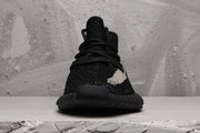Front view showing the rounded toe, black laces, textured upper, and ribbed sole.