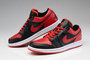 Pair of black and red low-top sneakers shown from angled side and front views.