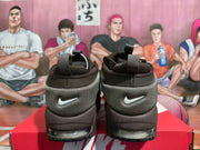 Rear view showing the heel panels and visible air units of the brown Nike sneakers