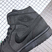 Close-up of the black sneaker side showing the tonal patterned upper, Swoosh, and ankle panel.
