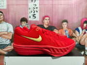 Side view of red Nike basketball shoe with gold swoosh and red outsole