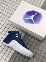Indigo and white Jordan sneaker pictured beside a Jordan-branded shoebox.