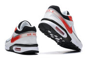 Rear and outsole views of white and red Nike Air Max sneakers
