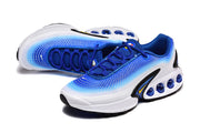 Angled view of blue and white sneakers with blue laces