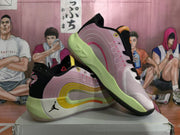 Angled side view highlighting the pink upper, layered side accents, and contrasting outsole.
