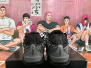 Rear view of black and grey Nike basketball sneakers showing the padded collars, patterned heel panels, and black outsoles.