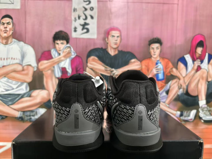 Rear view of black and grey Nike basketball sneakers showing the padded collars, patterned heel panels, and black outsoles.