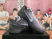 Angled view showing the textured upper, contrasting side branding, padded collar, and speckled sole.