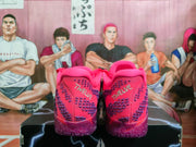 Rear view of pink and purple Nike sneakers showing textured heel panels and translucent purple outsoles on a graphic shoebox.