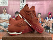 Angled view of a red sneaker pair showing the layered upper, lace area, side panels, and contrasting midsole details.