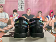 Rear view of the black sneakers showing multicolor collar panels and black heel sections.