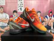 Pair of orange basketball shoes displayed at an angle, showing the Swoosh and heel design