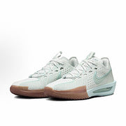 Pair of pale mint Nike basketball sneakers with brown-toned translucent outsoles.