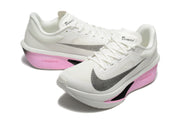 White Nike Zoom Fly 6 shoes with black side Swoosh graphics and pink, black, and white soles.
