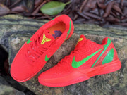 Top and side views of Nike Kobe 6 shoes showing the tongue emblem and green swoosh