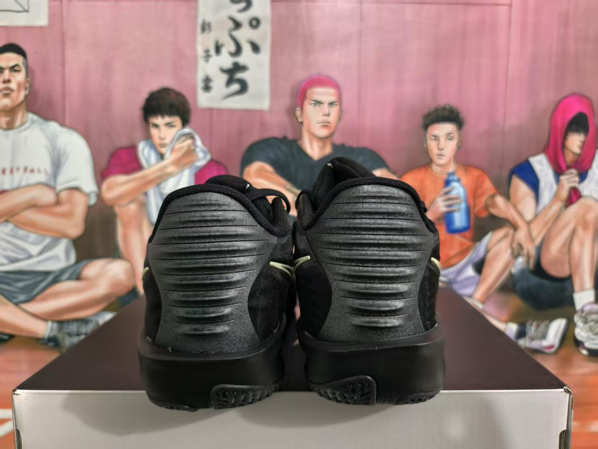 Rear view of a pair of black Nike basketball sneakers showing ribbed heel panels and dark outsoles.