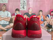 Rear view of red sneakers with textured heel panels and molded heel details.