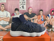 Side view of navy high-top basketball shoes with side Swoosh and white ridged soles.