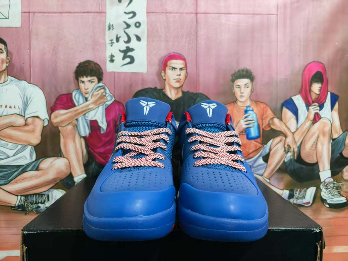 Front view of blue basketball sneakers with red and white patterned laces, photographed against an illustrated basketball-themed background.