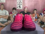 Front view of bright pink Nike basketball sneakers showing the laces, textured upper, and dark outsole.