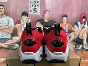 Rear view showing the red heels, black pull tabs, white midsoles, and black outsole sections.