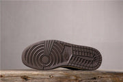 View of the dark outsole with circular and geometric traction patterns.