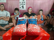 Front view of orange and white patterned Nike sneakers with blue laces and orange outsoles.