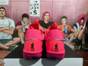Rear view showing perforated pink heel panels, silver accent details, and GT lettering on the heel tabs.