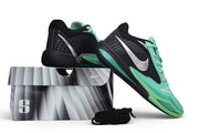 Black and green Nike Sabrina 4 shoes posed on a shoe box