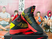 Black and yellow high-top basketball shoes with red outsoles, shown at an angle.