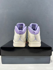 Rear view of the pair showing purple heel accents and Jumpman logos.