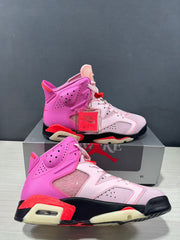 Close side view highlighting the pink high-top construction, perforated panels, and contrasting sole.