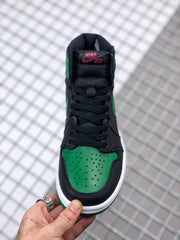 Front view showing the black laces, green perforated toe box, and white midsole.
