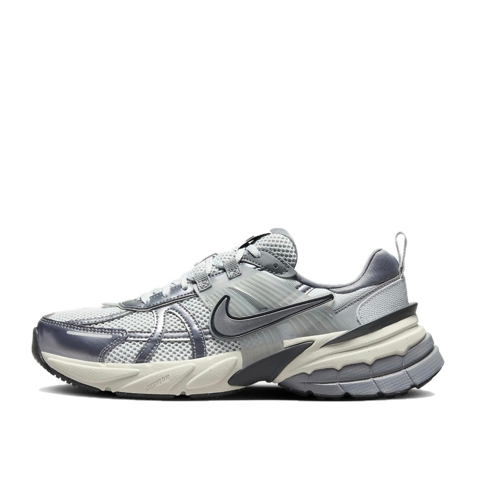 Side view of carbon gray Nike sneakers with a layered mesh-like upper, side Swoosh, and chunky sculpted sole.