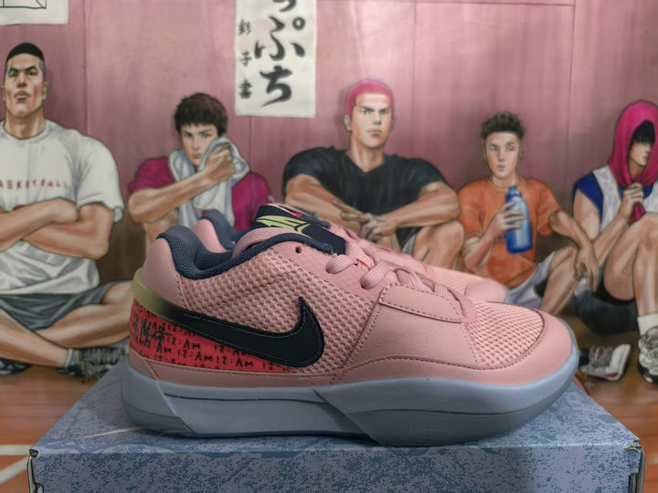 Side view of a pink Nike low-top sneaker with a black Swoosh, red patterned heel panel, dark lining, and gray outsole.