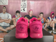 Rear view of the pink sneakers showing padded collars and decorative lettering on the heels.