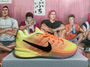Side view of yellow and orange Nike basketball shoes with a black Swoosh
