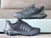 Black Alo hiking sneaker shown in profile with a textured toe area, layered side detailing, and rugged outsole.