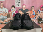Front view of black Nike GT basketball sneakers with padded tongues, black laces and patterned forefoot outsoles.