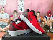 Angled view of red Nike basketball sneakers with black Swoosh logos and white outsoles