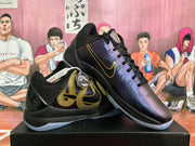 Angled view of the Nike basketball sneakers showing the gold side graphics, black heel sections, and translucent outsoles.